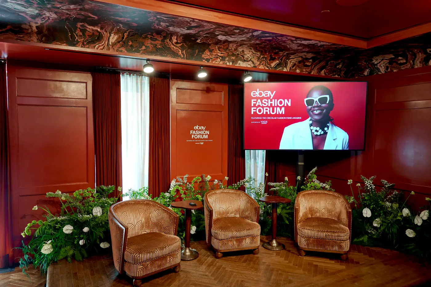 The Fashion Forum stage before doors: velvet armchairs and the Circular Fashion Fund Awards title screen