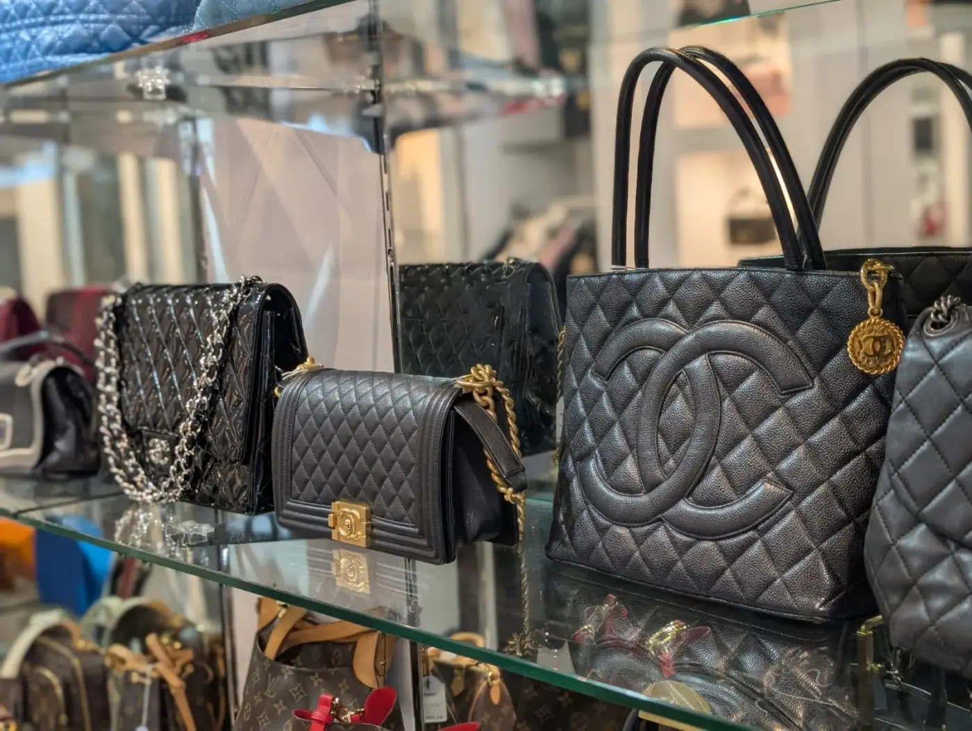 Quilted designer handbags displayed in a glass cabinet at Secondo, South Yarra